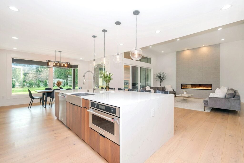 Bright modern kitchen and living area with pendant lights